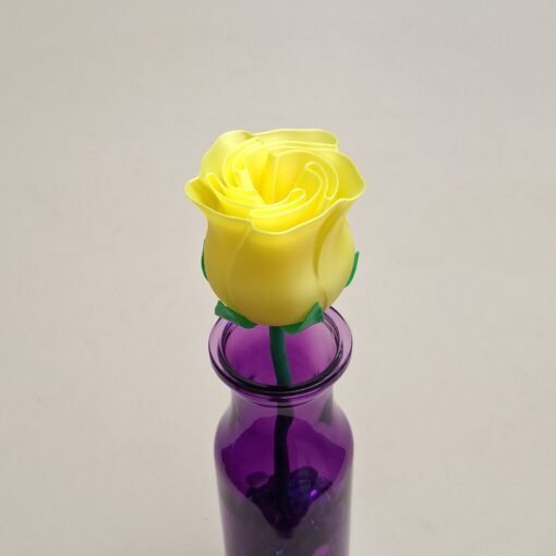 Small Yellow Rose in purple vase